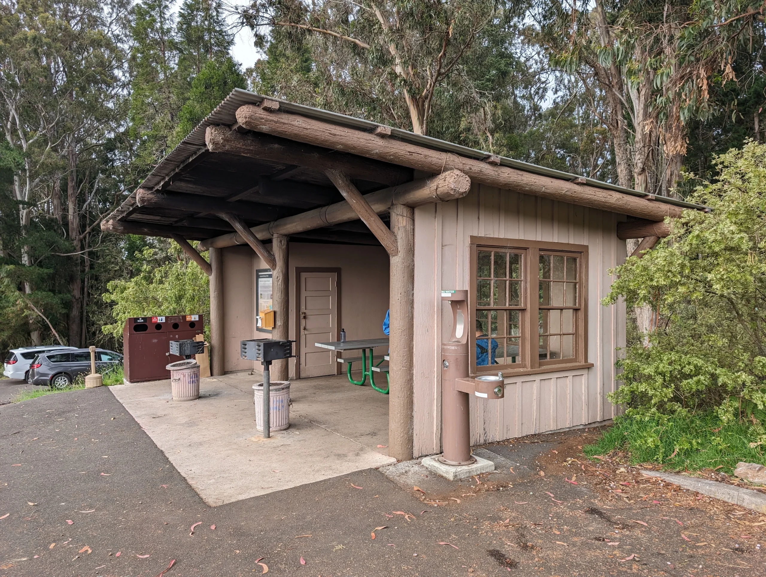 Picnic shelter and campground facilities at Hosmer Grove Campground in Haleakalā National Park, featuring picnic tables, grills, drinking fountain, and visitor information.