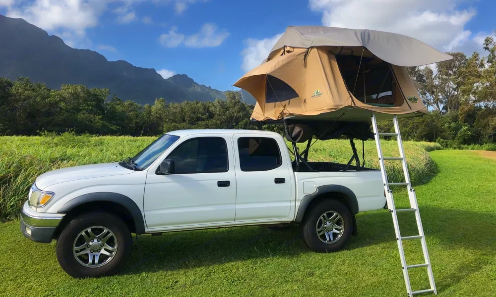 2004 Toyota Tacoma truck camper parked in Lihue, Hawaii. This 16-foot camper sleeps up to 3 people, accommodates 5 guests, has a 4.8-star rating from 47 reviews, offers unlimited mileage, and is not pet-friendly.