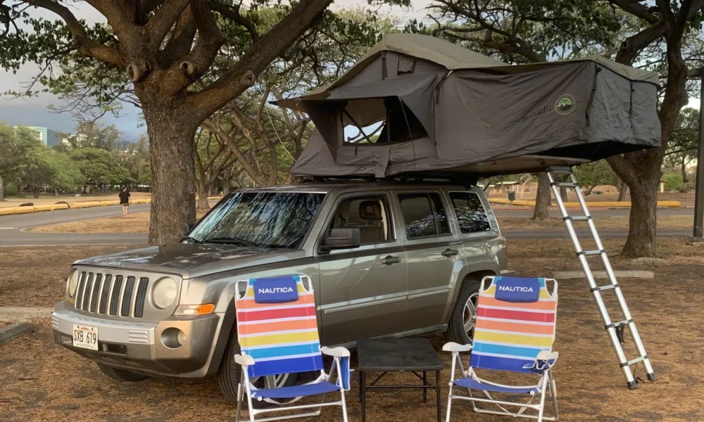 2008 Gold Jeep Patriot truck camper in Lihue, Hawaii. This 18-foot camper sleeps 2 guests, has a 4.4-star rating from 13 reviews, does not include a generator, and is not pet-friendly.