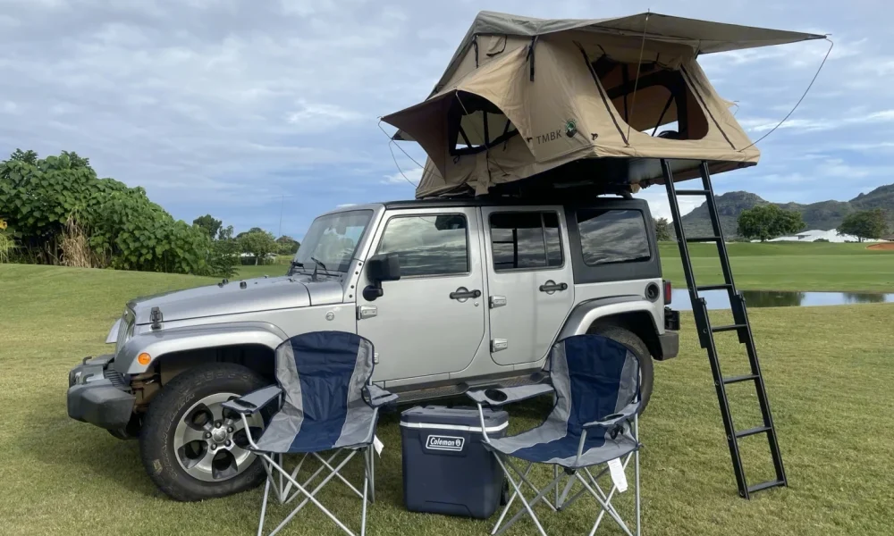 2016 Silver Jeep Wrangler truck camper in Lihue, Hawaii. This 18-foot camper sleeps 2 guests with a queen-size bed, has a 2.3-star rating from 3 reviews, does not include a generator, and is not pet-friendly.