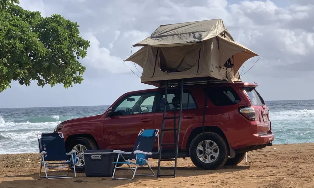 2017 Red Toyota 4Runner truck camper in Lihue, Hawaii. This 20-foot camper sleeps 2 guests with a full-size bed, has a 3.0-star rating from 1 review, does not include a generator, and is not pet-friendly.