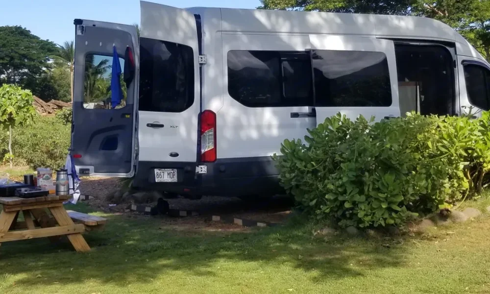 2018 Ford Transit camper van in Kihei, Maui, Hawaii. This 21-foot camper van sleeps up to 3 guests with a full-size bed, accommodates 3 passengers, has a 4.7-star rating from 69 trips, offers unlimited mileage, includes unlimited generator hours, and is not pet-friendly.