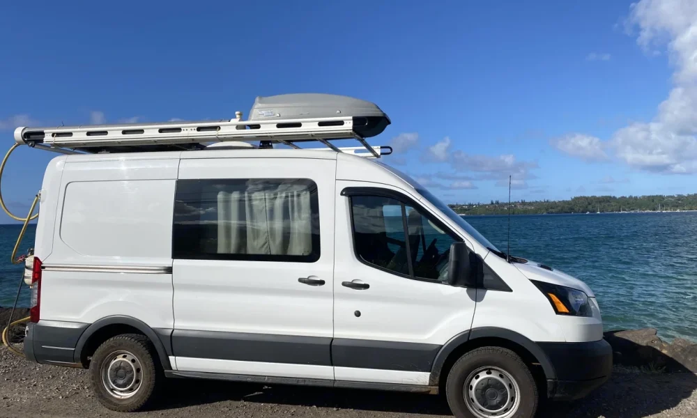 2018 Ford Transit camper van in Lihue, Hawaii. This 17-foot camper van sleeps 2 guests in a full-size bed, accommodates up to 3 passengers, has a 4.9-star rating from 18 reviews, offers unlimited mileage, and is not pet-friendly.