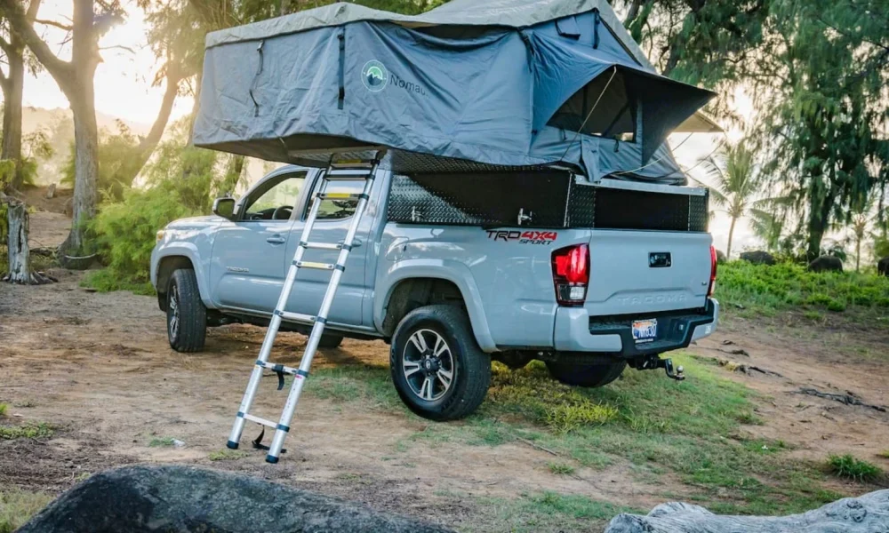 2019 Cement Toyota Tacoma truck camper in Lihue, Hawaii. This 18-foot camper sleeps 2 guests, accommodates up to 4 passengers, has a 4.6-star rating from 16 reviews, offers unlimited mileage, and is not pet-friendly.