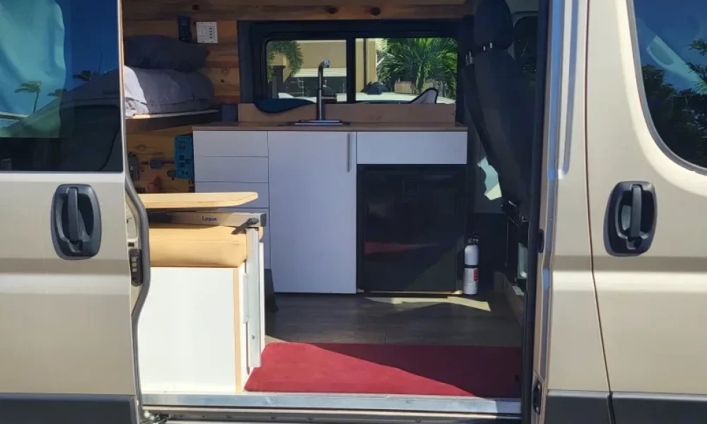 2021 Dodge Ram ProMaster Class B camper van in Kihei, Maui, Hawaii. This 17-foot camper sleeps 2 guests with one queen-size bed and one full-size bed, has a 5.0-star rating from 42 trips, offers delivery within 50 miles, includes unlimited mileage, does not have a generator, and is not pet-friendly.