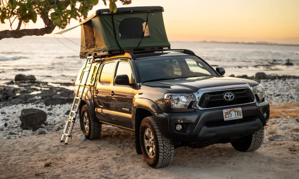 4x4 Toyota Tacoma truck camper in Kailua-Kona, Hawaii. This 16-foot camper is ideal for adventurous couples, sleeps 2 guests with a full-size bed, accommodates up to 5 passengers, has a 5.0-star rating from 15 reviews, offers unlimited mileage, and is not pet-friendly.