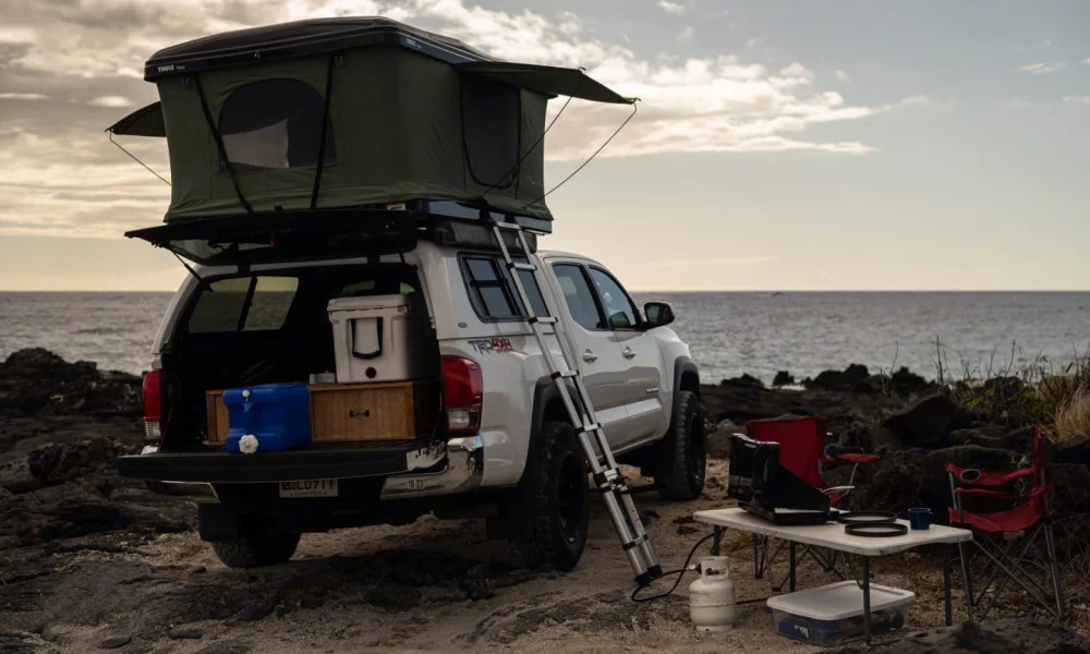 4x4 Toyota Tacoma truck camper in Kailua-Kona, Hawaii. This 18-foot camper sleeps up to 5 guests with two full-size beds, has a 4.9-star rating from 39 reviews, offers unlimited mileage, and is not pet-friendly.