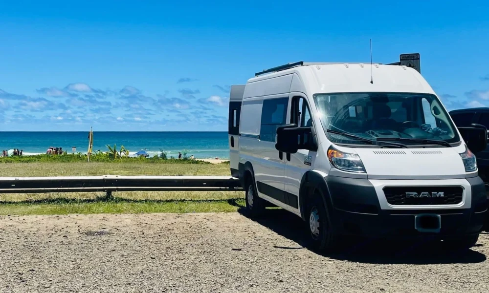 2021 Ram High Roof camper van in Lihue, Hawaii. This custom 18-foot camper van sleeps 2 guests in a full-size bed, has a 5.0-star rating from 56 reviews, offers unlimited mileage, and is not pet-friendly.