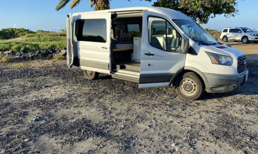 Carlos Vantana Class B motorhome in Kailua-Kona, Hawaii. This 19-foot camper sleeps 2 guests with a full-size bed, has a 4.8-star rating from 28 reviews, is pet-friendly, offers delivery within 45 miles, includes 100 free miles per day, and does not have a generator.
