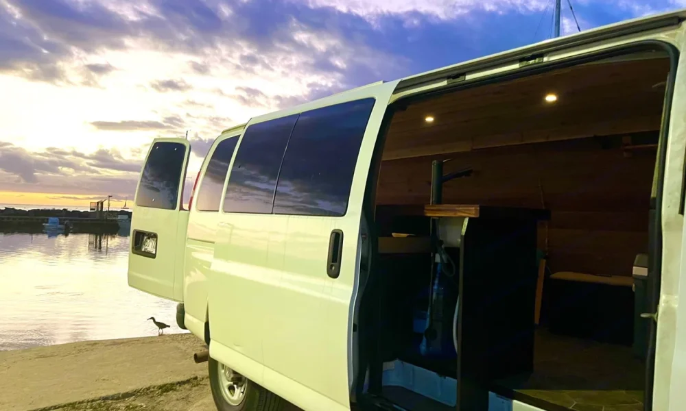 Chevy Express camper van in Honolulu, Hawaii. This 20-foot camper van sleeps 2 guests, has a 4.9-star rating from 87 trips, offers unlimited mileage, does not have a generator, and is not pet-friendly.