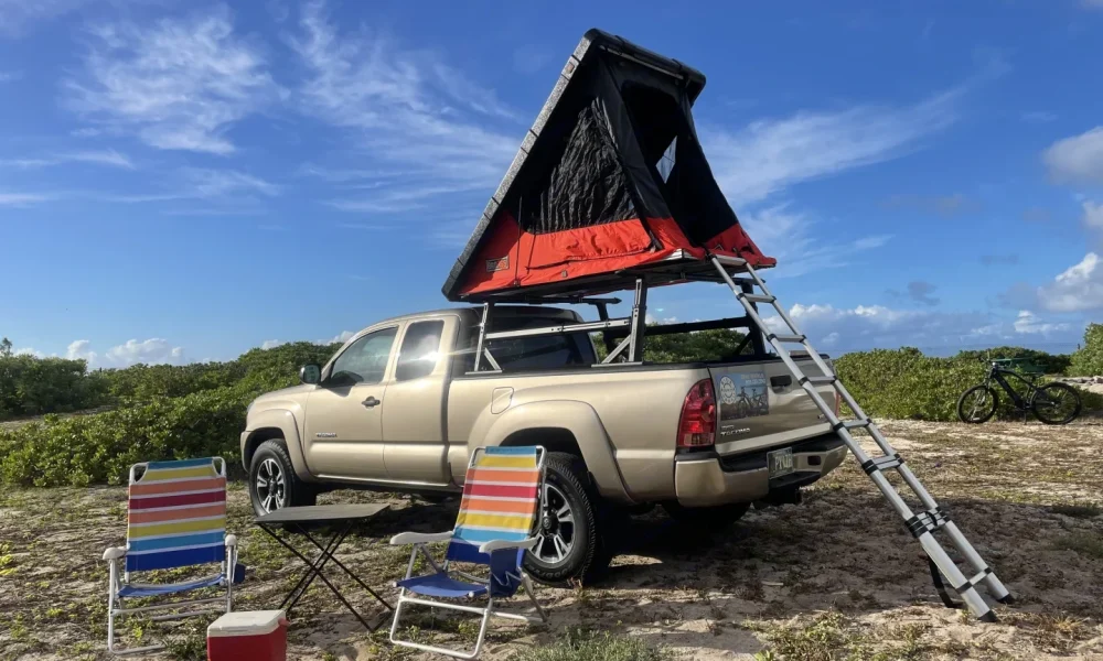 Golden Panda, a 2006 Toyota Tacoma truck camper in Honolulu, Hawaii. This 19-foot camper sleeps 2 guests with a full-size bed, accommodates up to 4 passengers, does not have a generator, and is not pet-friendly.