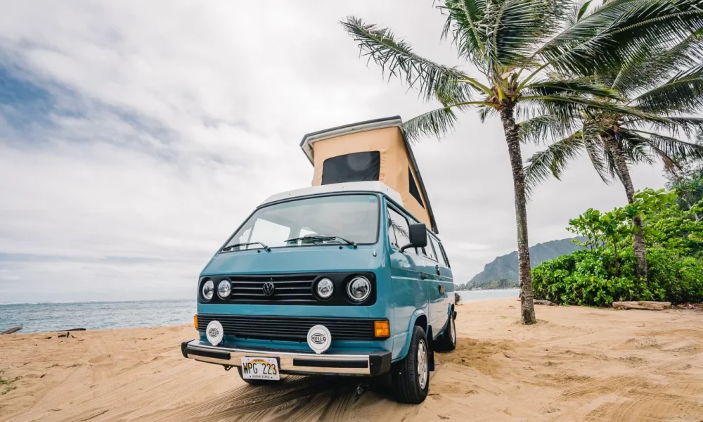 Indi Go, a 1982 Volkswagen Westfalia camper van in Wahiawa, Hawaii. This 15-foot camper van sleeps up to 4 guests with two full-size beds, accommodates 4 passengers, has a 5.0-star rating from 80 trips, does not have a generator, and is not pet-friendly.