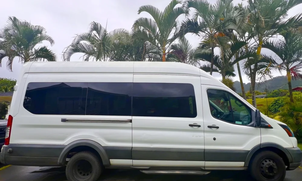 KOA KEA high-roof camper van in Kapaʻa, Hawaii. This 15-foot camper van features a sink, stove, and generator, sleeps 2 guests with a queen-size bed, has a 5.0-star rating from 10 reviews, offers delivery within 50 miles, includes unlimited mileage and unlimited generator hours, and is not pet-friendly.