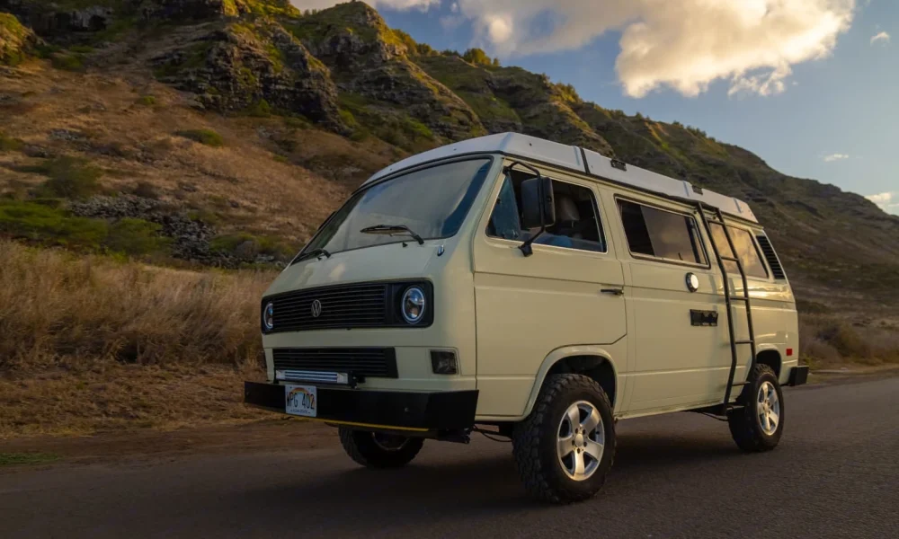 Lucy, a 1983 Volkswagen Westfalia camper van in Wahiawa, Hawaii. This 15-foot camper van sleeps up to 4 guests with two full-size beds, accommodates 4 passengers, has a 3.7-star rating from 88 trips, does not have a generator, and is not pet-friendly.