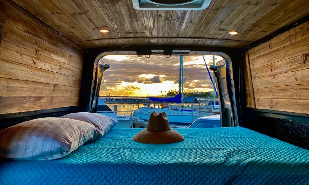 Nissan NV2500 high-roof camper van in Honolulu, Hawaii. This 20-foot camper van sleeps 2 guests, has a 4.9-star rating from 104 trips, offers unlimited mileage, does not have a generator, and is not pet-friendly.