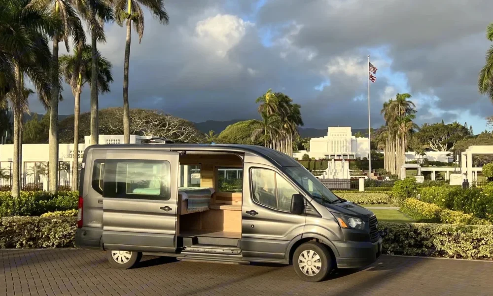 Oahu's Black Pearl camper van in Honolulu, Hawaii. This 18.32-foot camper van sleeps 2 guests with a queen-size bed, has a 4.4-star rating from 34 trips, is pet-friendly, offers unlimited mileage, and does not have a generator.