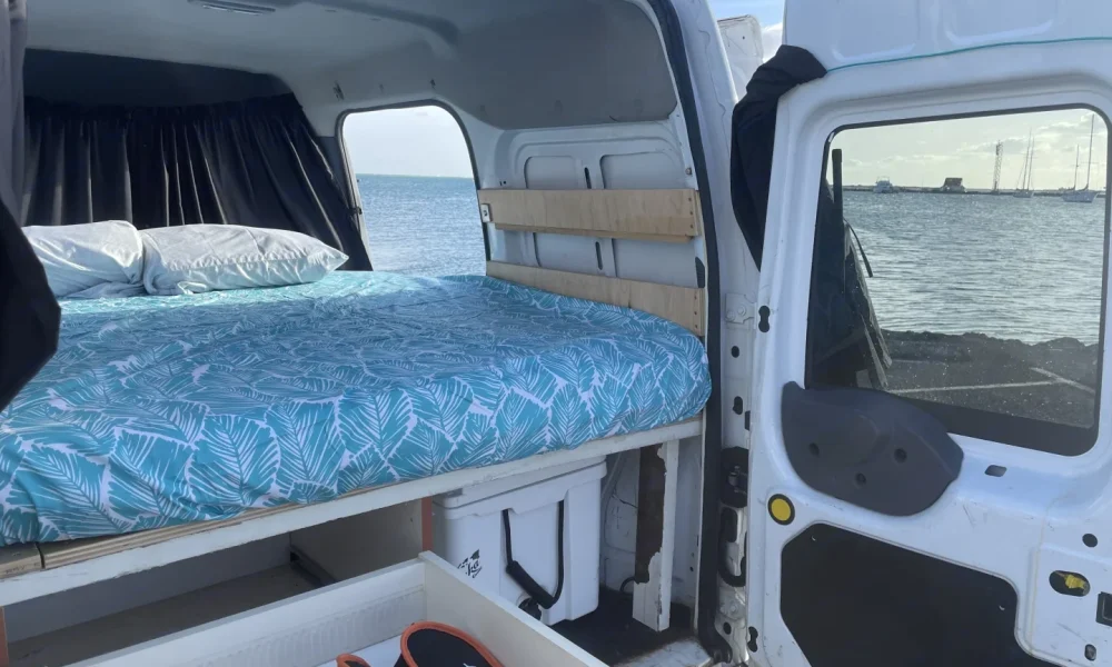 Stealth Camper II, a 2010 Ford Transit Connect camper van in Honolulu, Hawaii. This 18-foot camper van sleeps 2 guests with a full-size bed, has a 5.0-star rating from 18 trips, does not have a generator, and is not pet-friendly.